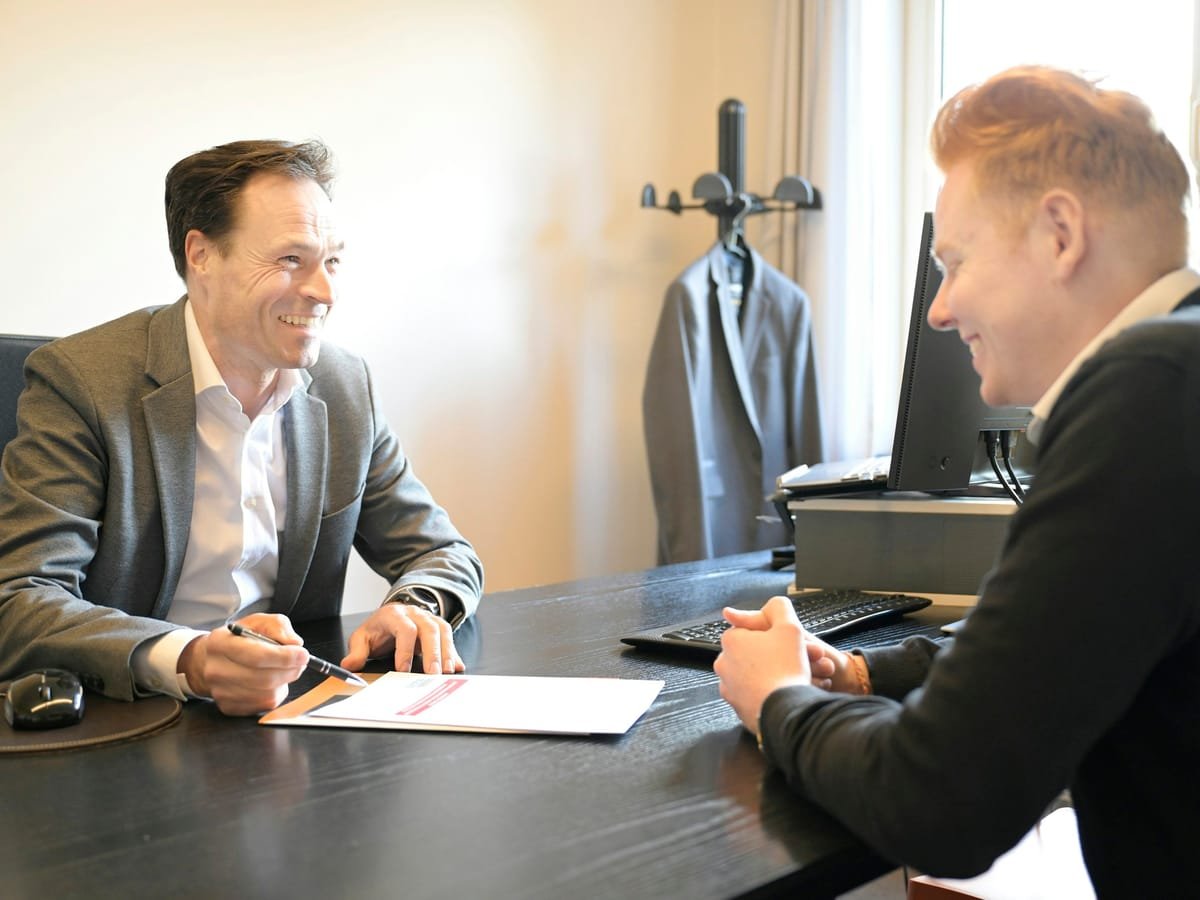 Consultant and client going over formation paperwork at a desk