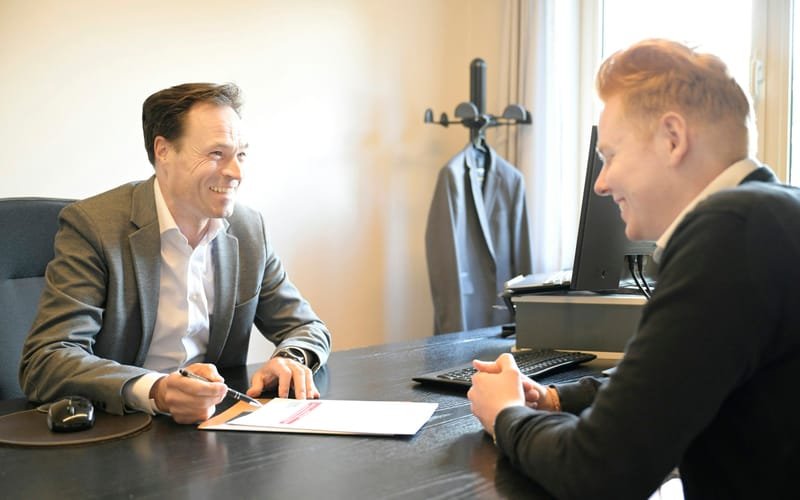 Consultant and client going over formation paperwork at a desk