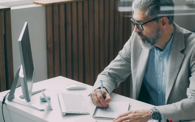 Business owner working through an application at a computer